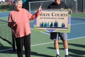 Washougal resident Tawn Wolfe (left) speaks to a crowd Sept. 25 while her husband Mike holds a sign proclaiming that the pickleball courts at Hathaway Park are now named "Wolfe Courts." (Photos by Doug Flanagan/Post-Record)