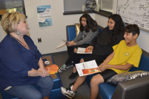 Jemtegaard Middle School counselor Kirstin Albaugh (left) talks with seventh-grader Laura Perez and eighth-graders Arianna Reyes-Piedra and Efrain Garcia on Sept. 30 about the College Bound Scholarship program, which will be a topic of conversation at the Washougal School District's next "Spanish Speaking Family Night" later this month. (Contributed photo courtesy of Rene Carroll)