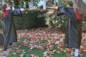 Doug Flanagan/Post-Record
Two children reenact a scene from one of the "Harry Potter" film franchise in front of Camas Public Library on Wednesday, Oct. 23, during the Downtown Camas Association's Boo Bash Trick or Treat 2019 event. Downtown streets were closed from 3 to 5 p.m. to allow costume-clad children collect candy or Halloween prizes from local businesses.