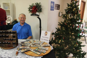 Bob Whetzel sits behind a display of his hand-crafted wooden pens, pencils and kitchen accessories at the Washougal United Methodist Church Holiday Bazaar on Saturday, Nov. 9. See more local holiday bazaar listings in the classified advertisements in today's Post-Record. (Kelly Moyer/Post-Record)