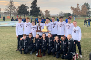 The Camas High School boys cross country team hoists the team's first team state championship trophy on Nov. 9 in Pasco. (Submitted photo courtesy of Matt Legrand)