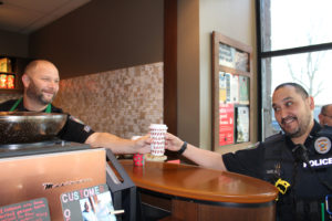 Camas Police Sergeant Scot Boyles (left) hands an espresso drink to Camas Police Detective David Garcia (right) during the "Coffee with a Cop" event at a Washougal Starbucks on Nov. 22. (Photos by Kelly Moyer/Post-Record)