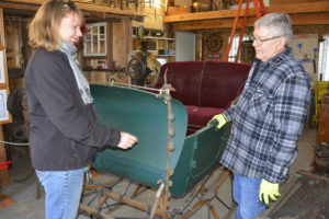 City of Washougal parks and cemetery manager Suzanne Grover (left) and Richard Johnson of the Camas-Washougal Historical Society (CWHS) talk about the vintage sleigh donated by the CWHS to the city earlier this month. (Contributed photo courtesy of Rene Carroll)