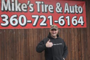 Mike's Tire and Auto owner Mike Luepke stands in front of his Washougal shop on Jan. 9. The building that houses Luepke's business was severely damaged by a fire last October, and since then he's been trying to remind people that his shop is still open. (Photos by Doug Flanagan/Post-Record)