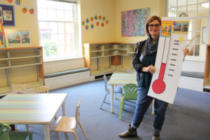 Camas Library Director Connie Urquhart holds a fundraising barometer inside the library's storytime room Jan. 17, 2019. (Kelly Moyer/Post-Record files)