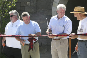 Former Washougal Mayor Jeff Guard (far left) cuts a ribbon for the grand opening of the Washougal Pedestrian Tunnel in 2010. Guard, who died on Tuesday, Feb. 4, is pictured with his brother, Sean Guard (second from left), then mayor of Washougal; former Third District Congressman Brian Baird (second from right); and former Washougal Mayor Les Sonneson (right). (Post-Record file photo)