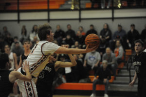 Washougal senior Jakob Davis makes a three point play against Woodland on Jan. 30. (Wayne Havrelly/Post-Record)