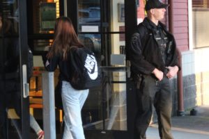 Washougal Police Department officer Kelly Anderson, the Washougal School District's school resource officer, greets students entering Washougal High School on Feb. 18. (Doug Flanagan/Post-Record)