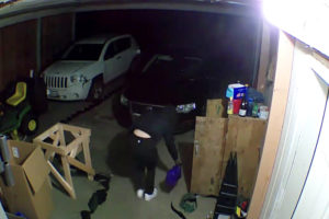 Photo from video provided by Skamania County Sheriff's Office 
 A still photo taken from a video provided by the Skamania County Sheriff's Office shows a person pouring what appears to be accelerant around a vehicle inside a garage at a Carson, Wash., residence on July 22. Sheriff's deputies later arrested a Camas teen in connection to the arson investigation.