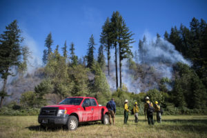 Fire crews work the Washougal River Road fire just past mile marker 5 near Washougal on Tuesday, Sept. 8. By Wednesday, Sept. 9,  the fire was 100-percent contained. (Alisha Jucevic courtesy of The Columbian)