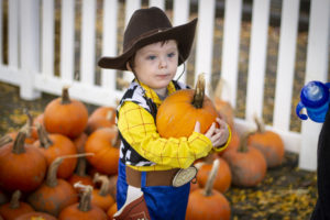 A child holds a pumpkin during the 2019 Washougal Harvest Pumpkin Festival. This year's event, to be held on Saturday, Oct. 24, will feature a parade led by city officials, who will pass out toys, treats and pumpkins to children at five city landmarks. (Contributed photo courtesy of Michele Loftus)