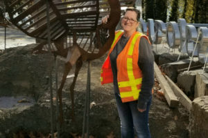 Former Washougal resident Angela Ridgway stands with "Millie," one of two metal herons that she created for display at the roundabout on Highway 14 and Washougal River Road. (Contributed photo courtesy of Angela Ridgway)