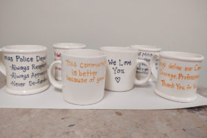 Mugs crafted at the Earth, Glaze & Fire pottery studio in Vancouver show messages of support for Camas police officers, sent in by Camas residents over the past few months. Camas resident Scott Gee spearheaded the project and plans to deliver the mugs to the Camas Police Department later this month. (Contributed photo courtesy of Scott Gee)