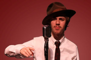 Washougal High School drama student Elijah Mitchell-Hopmeier performs during the school's performance of "War of the Worlds: The Panic Broadcast," which will be available for viewing on the Broadway on Demand website March 19-21. (Contributed photo courtesy of Marcus Bennett)