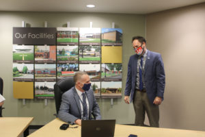 Camas School District Superintendent Jeff Snell (left) speaks to Doug Hood, the district's director of elementary education, after a Camas school board meeting on April 1, 2021. (Kelly Moyer/Post-Record)