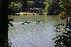 Kayakers on Camas' Lacamas Lake pass by Lacamas Lake Lodge on Sunday, July 26, 2020. (Kelly Moyer/Post-Record files)