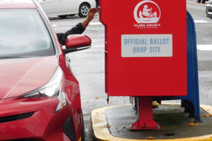 A voter drops off a ballot in the 24-hour ballot drop box next to the Camas Post Office on Oct. 29, 2018. (Post-Record file photo)