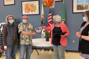 Washougal Mayor Molly Coston (second from right) presents Cindy Reidel (far left) and Tom Pastore (second from left) with a "Hometown Hero" award in recognition of their community service. (Doug Flanagan/Post-Record)