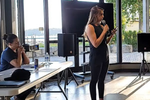 Melissa Mcilwain (right), of the Washougal Moms group, speaks at an event at the Black Pearl on the Columbia event center while Patricia Bellamy (left) listens on Tuesday, June 22, 2021. (Screenshot by Doug Flanagan/Post-Record)