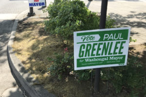 Signs promote the Washougal mayoral campaigns of Paul Greenlee and Derik Ford in downtown Washougal. Both candidates have reported stolen signs in the lead up to the Aug. 3 primary election. (Doug Flanagan/Post-Record)