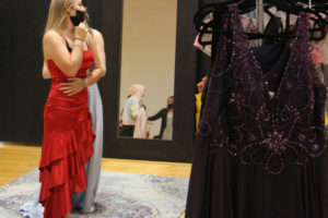 Washougal High School senior Taylor Poulsen tries on a dress during the "Giving Gown Gala" event at Washougal High School on Oct. 8, 2021. (Photos by Doug Flanagan/Post-Record)