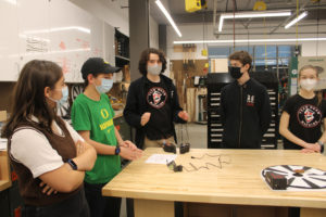 Camas students discuss the work that went into creating their Power Pivot health care device inside Discovery High School’s STEM lab on Wednesday, Dec. 1, 2021. Pictured from left to right are: Silvia Pujol, 13, a freshman at Discovery; Jack Harding, 15, a sophomore at Discovery; Will Jolley, 17, a junior at Discovery; Brenden Cavill, 15, a 10th-grader at Discovery; and Taryn Cavill, 14, an eighth-grader at Odyssey Middle School.  (Kelly Moyer/Post-Record)