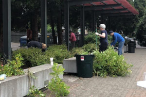 A group of local residents, organized by Washougal Mayor Rochelle Ramos -- then a Washougal Parks Board member -- clean Washougal's downtown Reflection Plaza in July 2021. The city of Washougal is implementing a program that allows individuals or groups to "adopt" a city park and help with tasks such as litter pick-up, graffiti removal and flower planting. (Contributed photo courtesy of Washougal Mayor Rochelle Ramos)