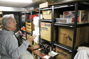 Two Rivers Heritage Museum volunteer Karen Johnson shows a vistor some of the stored items in the museum's basement on Thursday, March 31, 2022. (Photos by Doug Flanagan/Post-Record)