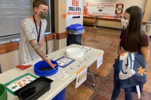 Washougal School District professional technical assistant Alex Yost (left) talks to Washougal High School student Shannon Brennan about the school cafeteria's new sorting tables in 2021. (Contributed photo courtesy of the Washougal School District)