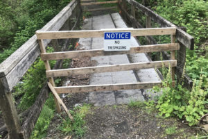 A barrier blocks a damaged pedestrian bridge in Washougal's Hartwood Park in May 2022. (Doug Flanagan/Post-Record)