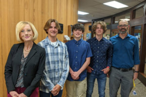 Washougal School District Superintendent Mary Templeton (far left) gathers with Washougal High students (from left to right) Brandon Austenfeld, Miles Brown and Wiliam Logan, and Washougal High engineering teacher Jason Blaesing (far right) inside Washougal City Hall on Monday, May 24, 2022. (Contributed photo courtesy of the Washougal School District) 