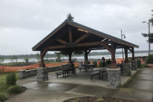 Picnic shelter users attempt to dodge raindrops at Washougal Waterfront Park on June 3, 2022. The Port of Camas-Washougal has proposed doubling its rental fees for the shelter in 2023. (Doug Flanagan/Post-Record)