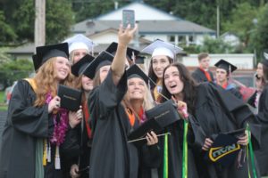 Doug Flanagan/Post-Record 
 A group of graduates poses for a selfie at the conclusion of their commencement ceremony at Fishback Stadium on Saturday, June 11. (Doug Flanagan/Post-Record)