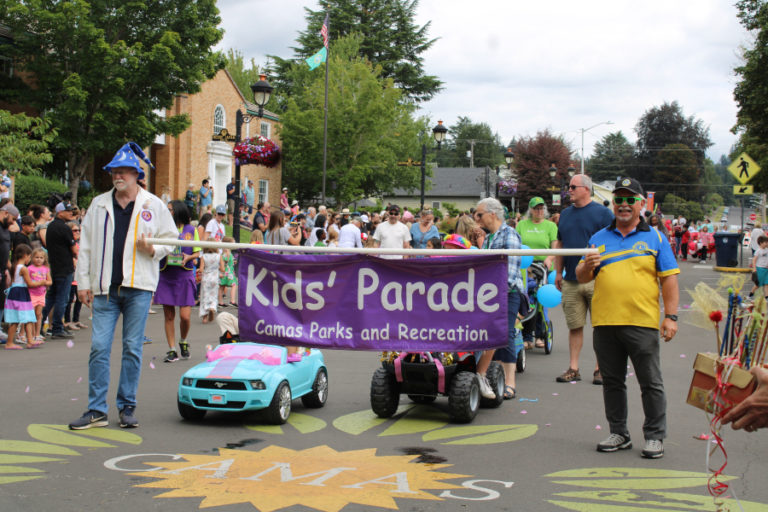 Sign-bearers help lead the 2022 Camas Days Kids Parade Friday, July 22, 2022, near the Camas Public Library.