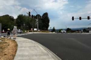 A couple walks near the intersection of Northwest Brady Road and 16th Avenue on Aug. 1, 2022. (Kelly Moyer/Post-Record files)