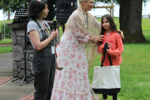 Cape Horn-Skye  Elementary and Canyon Creek Middle school art teacher Alice Yang (left) announces the winner of the first Parkersville Day student art contest at Parker's Landing Historical Park in Washougal on June 4, 2022. The Washougal Art and Culture Alliance named Yang as the group's 2022 Community Member of the Year. (Doug Flanagan/Post-Record files)