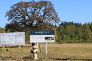 A sign at the corner of Northwest Lake Road and Northwest Friberg-Strunk Street in Camas announces the proposed Oak Tree Station food cart development on Friday, Sept. 23, 2022. (Kelly Moyer/Post-Record)