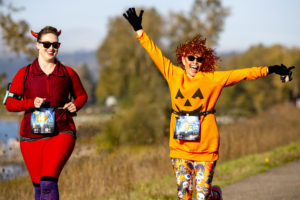 Lindsay Smith, of Vancouver (left), and Vicki Green run in WhyRacing's Scary Run on Oct. 31, 2020, in Washougal. (Photo courtesy of The Columbian files)