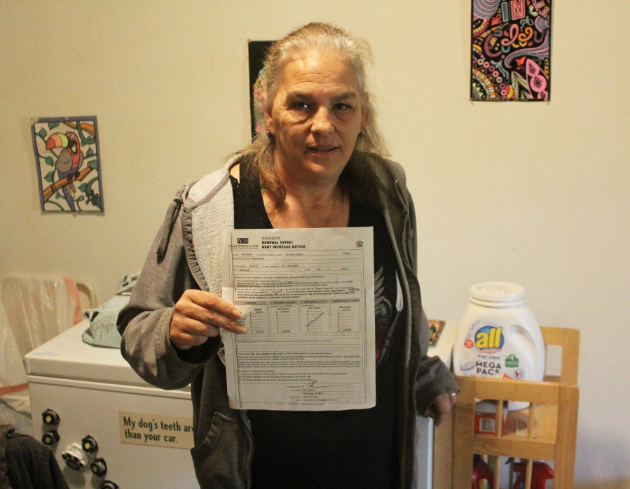 Washougal resident Saree Adams on Oct. 13, 2022, shows a rent-renewal offer she received for her apartment at Rockwood Terrace. Adams and other tenants are facing an unexpected rent increase of almost $400 per month, a price many at the low-income, tax-abated Washougal apartment complex say they cannot afford. (Doug Flanagan/Post-Record)