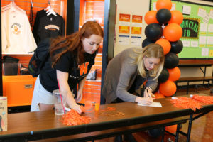 Washougal High School marketing student Samantha Mcray-Smith (left) and business teacher Nicole Simek process orders at the Washougal Co student  store in November. (Contributed photo courtesy Washougal School District)