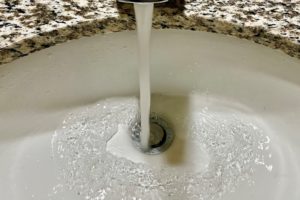 Water pours from a faucet on Jan. 24, 2023. (Photo by Kelly Moyer/Post-Record)