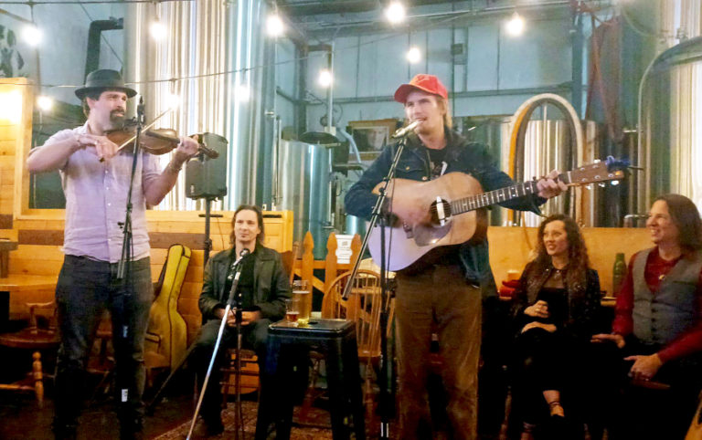 James Rossi (left) and Marcus Angeloni (center) perform during a Washougal Songcraft Festival song circle event on Thursday, Nov. 3, 2022, at 54-40 Brewing Company in Washougal.