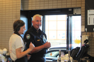 Camas Police Chief Mitch Lackey (right) serves customers at a Washougal Starbucks drive-thru as part of the 2022 Coffee with a Cop event Sept. 23, 2022. (Kelly Moyer/Post-Record files)