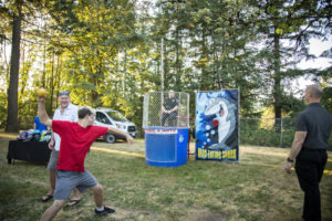 Contributed photo courtesy city of Washougal 
 Washougal Mayor David Stuebe (left) watches a local resident attempt to "dunk" Washougal Police Captain Zane Freschette in a "dunk tank" during the city's National Night Out event at Hathaway Park in August 2022. Stuebe told the Post-Record that he wants to see "people outside, engaged, contributing to their community, enjoying we have, but respecting it and taking pride in it."