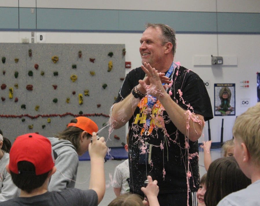 Mark Bauer, Gause Elementary School's physical education teacher, laughs after being covered with "silly string" on Tuesday, March 28, 2023. (Doug Flanagan/Post-Record)