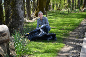 Port of Camas-Washougal Commmissioner Cassi Marshall picks up trash and debris from the Washougal Waterfront Trail during the Port's Earth Day cleanup event in April 2022. (Contributed photo courtesy of Cassi Marshall)