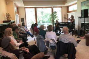 Musician Heather Keizur (right) talks to attendees at the home of Washougal resident Chuck Carpenter during a Washougal Arts and Culture Association 