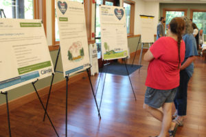 Residents peruse informational displays during a city of Camas open house to discuss Camas lakes' water quality held Wednesday, July 12, 2023, at Lacamas Lake Lodge in Camas. (Kelly Moyer/Post-Record)