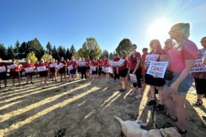 Members of the Camas Education Association, the union representing 450 Camas educators, hold signs showing support for Camas teachers ahead of bargaining negotiations with the Camas School District Wednesday, Aug. 16, 2023. (Contributed photo courtesy of Camas Education Association)