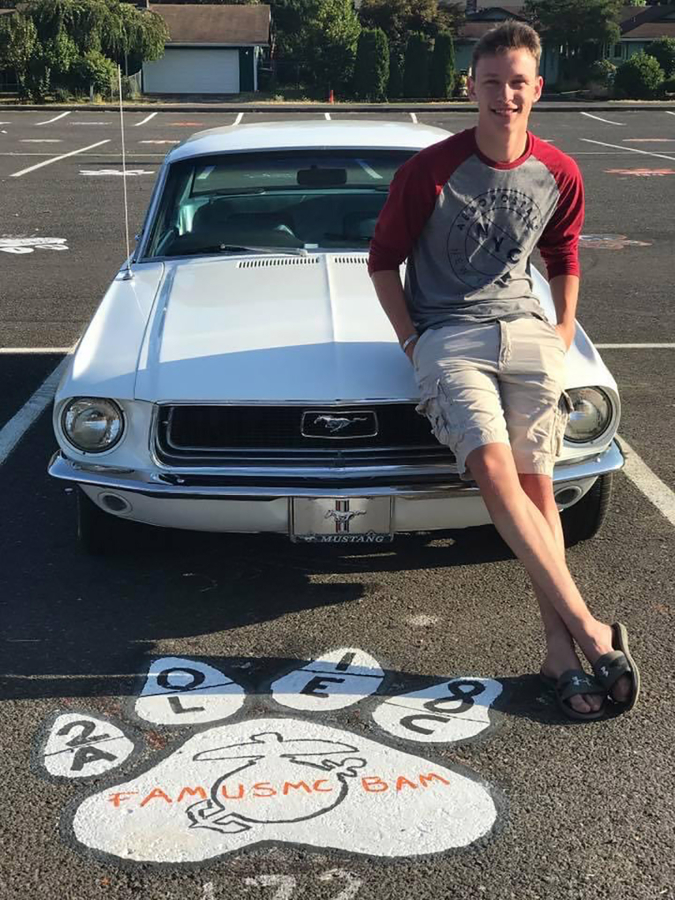 Contributed photo courtesy Alec Langen 
 Washougal High School graduate Alec Langen poses for a photograph with his car in his school parking space in 2018.